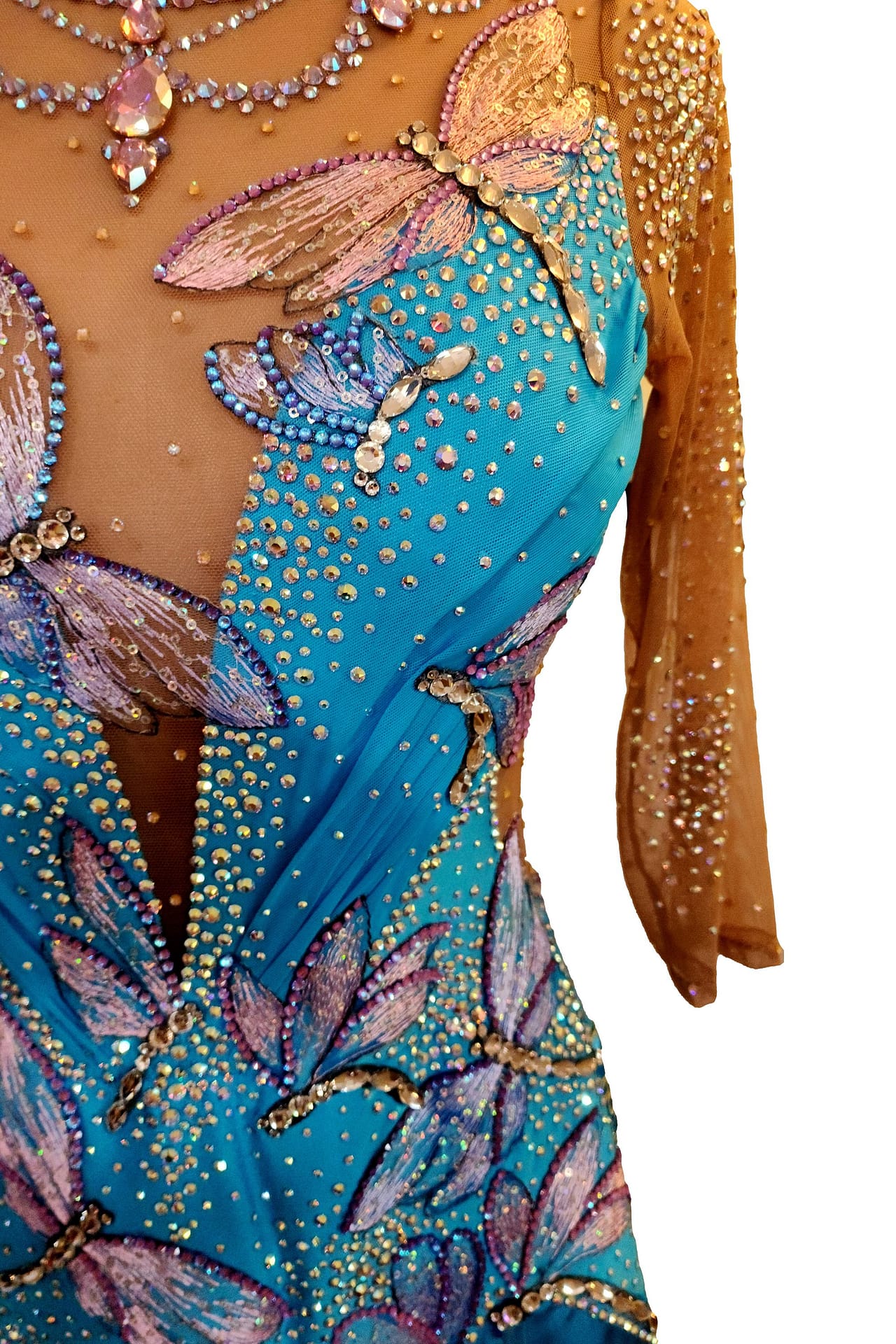 Dragonfly ballroom dress — bodice detail — close-up of the turquoise fabric, showing the texture and stoning of the large pink-winged dragonfly patches and the illusion crystal necklace design.