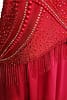 Crimson Flame dress — stonework close-up - red pearl and rhinestone accents forming a fan pattern above the fringe.