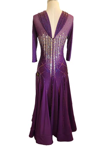 Purple ballroom gown — back view — deep V-back with sheer mesh, 3/4 sleeves, and vertical crystal accent lines.