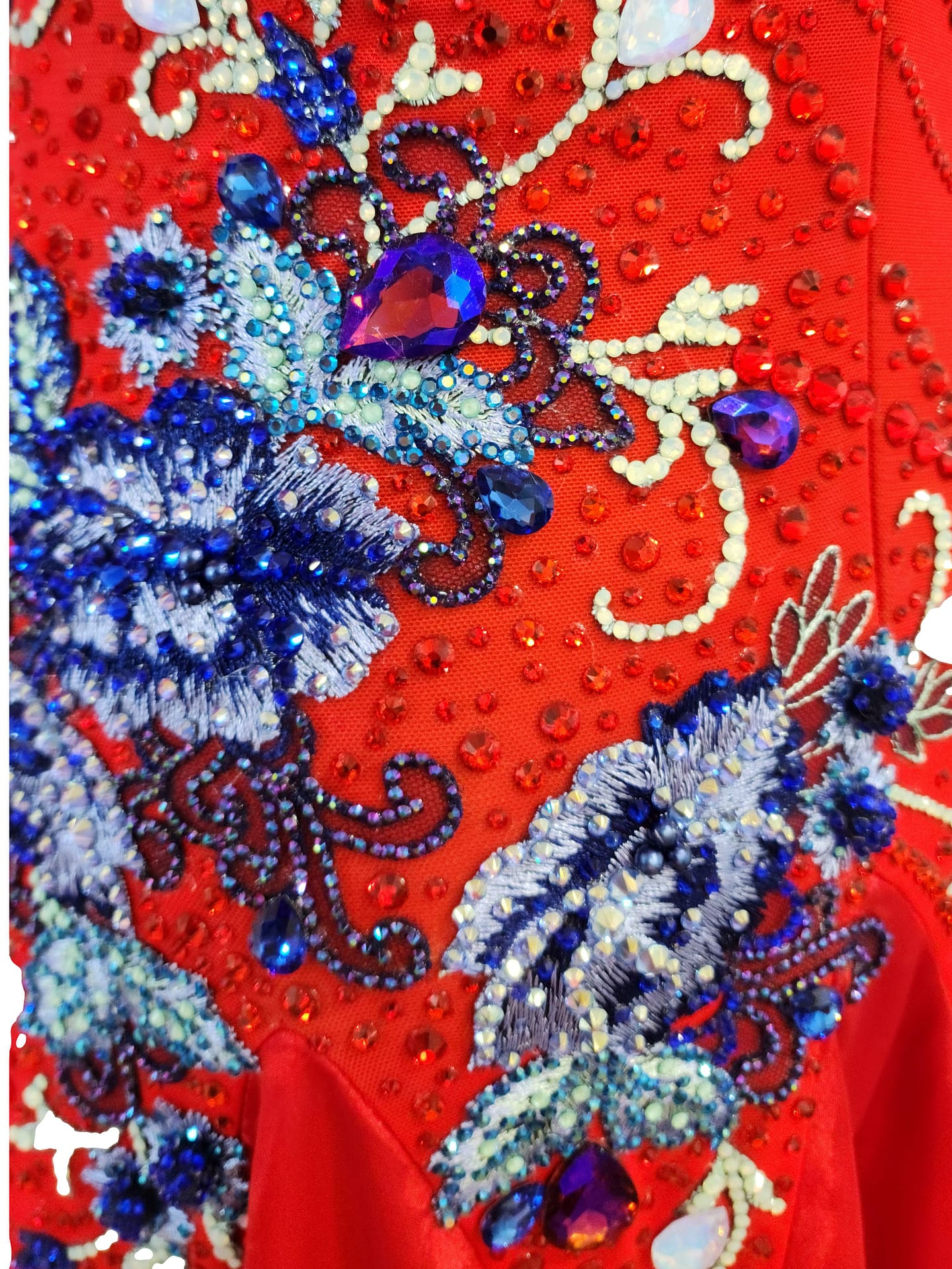 Garnet Bouquet Ballroom Dress - stonework close ‑ up featuring intricate blue and white beadwork and crystal floral appliqués on red fabric.