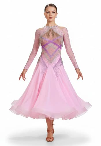 Labana ballroom gown — front view — Long-sleeved, pale pink Standard gown with a sheer mesh yoke, detailed geometric stoning in purple and AB crystals, and silver beaded fringe across the chest and shoulders.