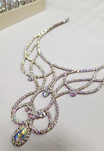 Close-up detail of crystal AB stones arranged in flowing ballroom necklace design