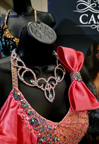 Crystal ballroom necklace worn on competition dress, showcasing elegant scroll design and stage-ready sparkle
