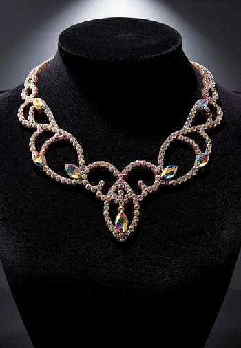 Ballroom competition necklace displayed on black bust, highlighting symmetrical crystal scroll design and center drop
