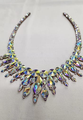 Detailed view of faceted crystal AB stones arranged in statement design for ballroom dancing