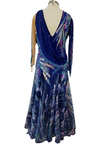 Royal Horizon ballroom dress back view showing draped bodice, crystal accents, and flowing patterned chiffon skirt