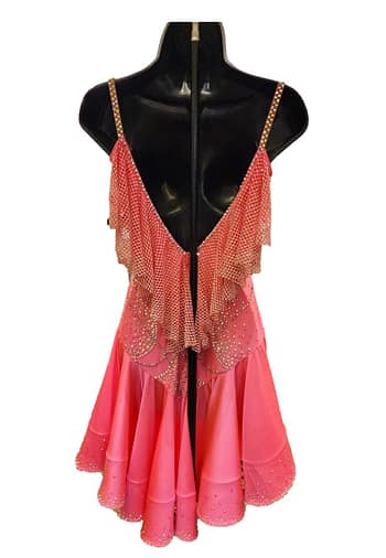 Saffron Heat Atelier Latin dress front view in coral with crystal embellishments, draped neckline, cutout sides, and layered ruffle skirt