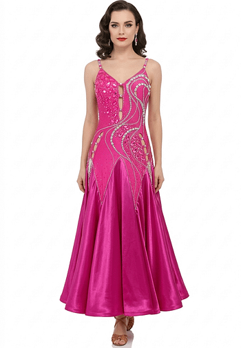 Bold, vibrant, and effortlessly captivating, Malibu Dream is a ballroom gown created for dancers who want to command attention with color, sparkle, and fluid movement. This striking hot pink design blends radiant energy with refined elegance, delivering a look that feels both playful and powerfully sophisticated. The bodice is richly embellished with dense rhinestones and luminous crystal stones arranged in flowing, sculpted patterns that enhance and contour the figure. A delicate front cutout detail adds modern allure while maintaining a polished and elegant finish. The fitted silhouette elongates the body’s lines, while the intricate crystal placement catches the light from every angle, creating a dazzling visual effect on the floor. Flowing into a luxurious satin skirt, Malibu Dream offers beautiful fullness and graceful movement with every step. The soft, sweeping fabric creates a dynamic contrast to the structured bodice, ensuring both comfort and dramatic presence in motion. From the brilliant crystal detailing to the vibrant color and fluid skirt, Malibu Dream is designed for dancers who want high visibility, confident expression, and timeless ballroom glamour. Features Ballroom gown Vibrant hot pink color for standout floor presence Embellished with dense rhinestone work and large crystal accents Elegant front cutout detail Flattering fitted silhouette Luxurious satin skirt for smooth, flowing movement Designed to shimmer beautifully under ballroom lighting Size 2–4 Perfect For Smooth, showcase performances, and dancers who want bold color with a glamorous, high-impact look.