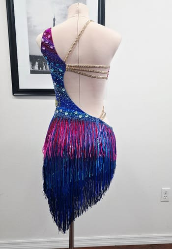 Chromatic Fire Latin dress full back view with fringe skirt and rhinestone strap accents