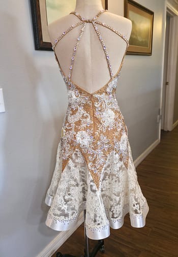 Lace Temptation dress shown from the back, featuring an open back with embellished rhinestone straps and a lace skirt