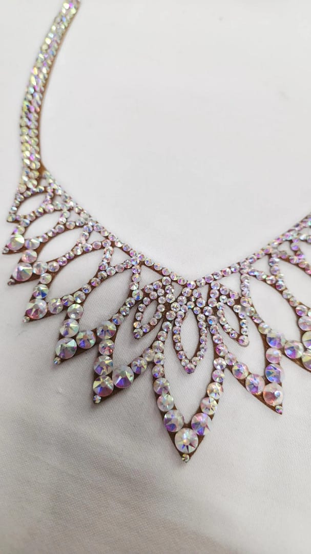 Close-up of crystal AB stones arranged in symmetrical ballroom necklace pattern