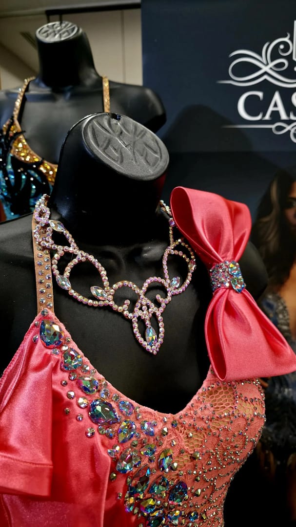 Crystal ballroom necklace worn on competition dress, showcasing elegant scroll design and stage-ready sparkle