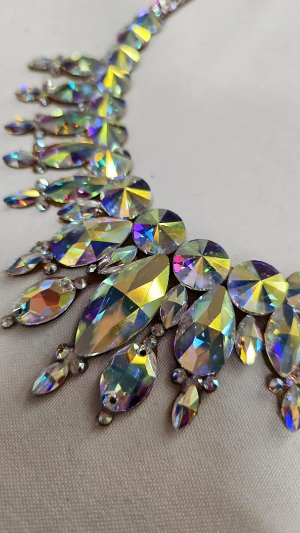 Close-up of oversized crystal AB stones used in large ballroom necklace for high-shine competition sparkle
