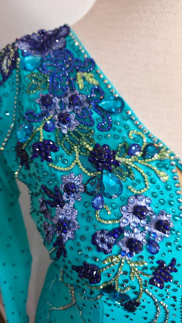 Electric Bloom ballroom dress shoulder detail with intricate blue floral crystals and beadwork