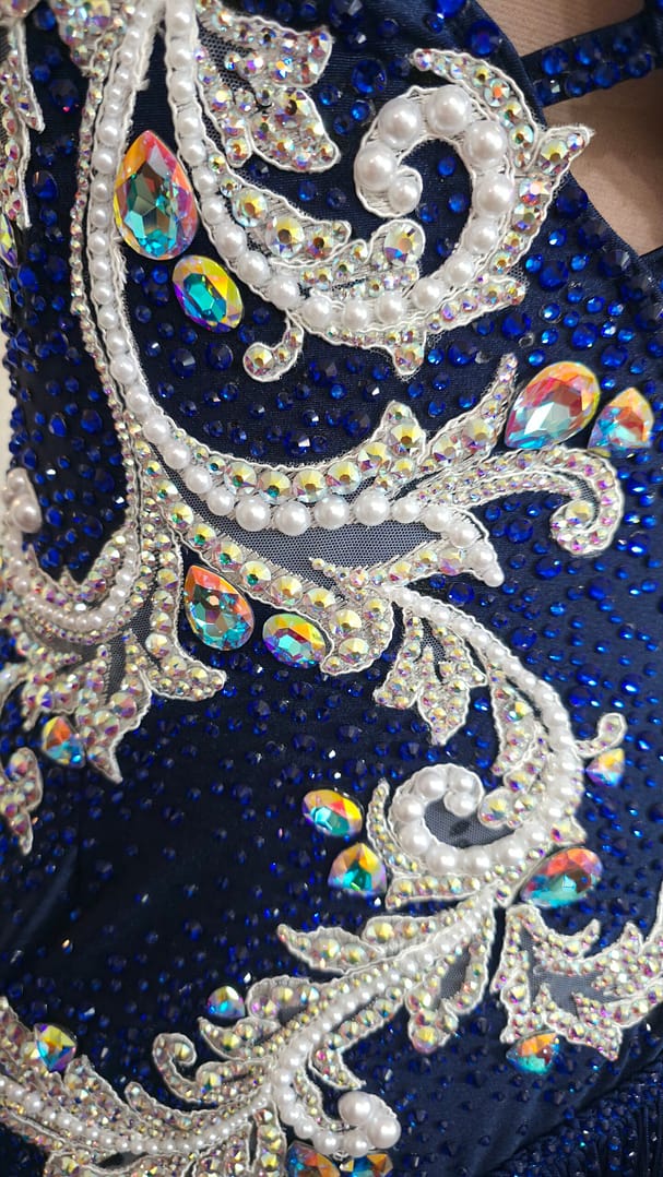 Close-up of pearl and crystal embroidery on the Aurora Royale sapphire blue Latin dance dress.