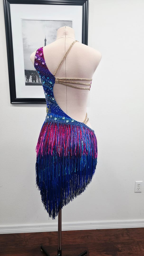 Chromatic Fire Latin dress full back view with fringe skirt and rhinestone strap accents
