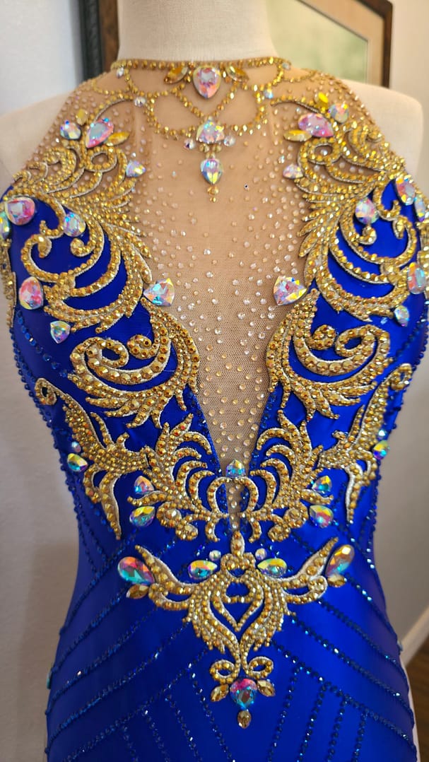 Royal Aurum Dress bodice close-up featuring gold appliqué and iridescent crystal stones on illusion mesh