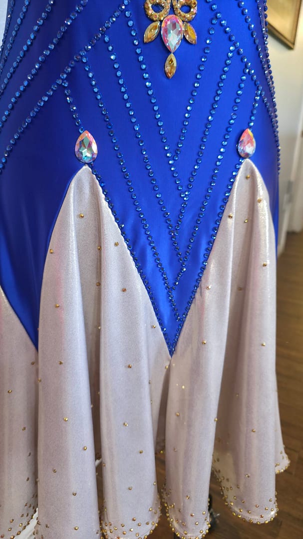 Royal Aurum Dress skirt detail showing nude panels with rhinestones and flowing Latin movement design