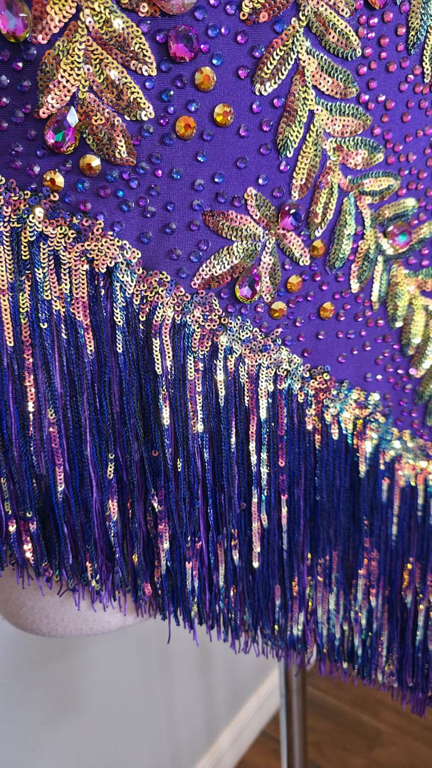 Close-up of Velvet Velocity asymmetrical fringe skirt with shimmering sequins and movement-enhancing Latin dance design.
