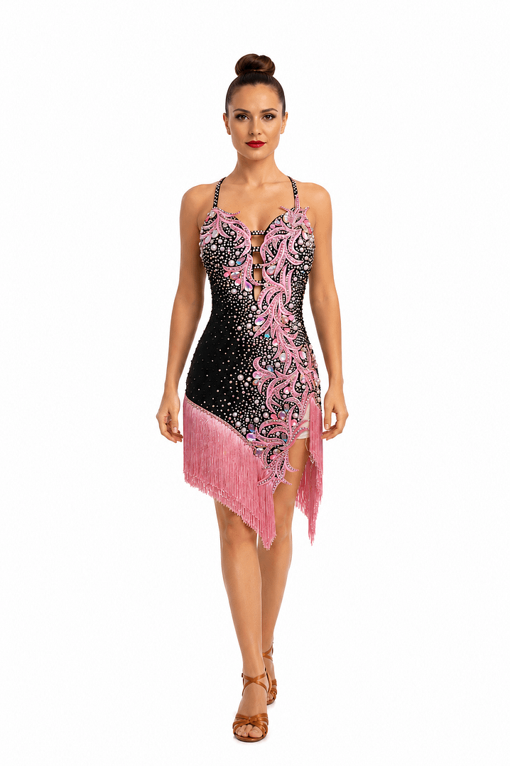 Blush Noir luxury Latin dance dress featuring pink crystal appliqué, pearl embellishments, black base fabric, and flowing fringe accents.