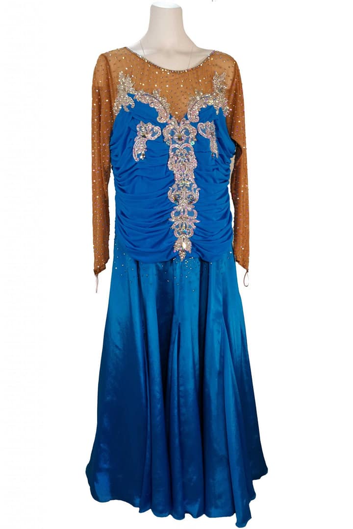 Paz Ballroom Dress – Front View — royal-blue ballroom gown with ruched bodice, nude mesh illusion neckline, and ornate silver appliques vertically placed down the front.