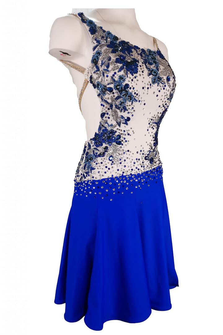 Manon Latin dress — 3/4 view — sparkling blue and clear crystals on white mesh bodice and short, flared skirt