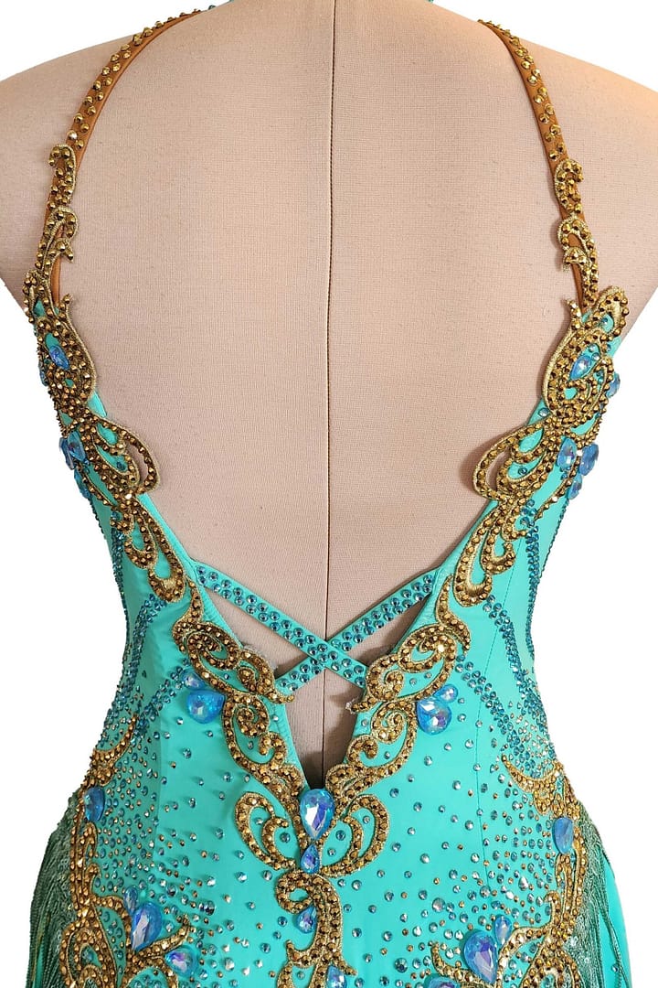 Ashcroft Latin Dress - back closure detail - Gold scrollwork, teal stones, and criss-cross straps on open V-back.