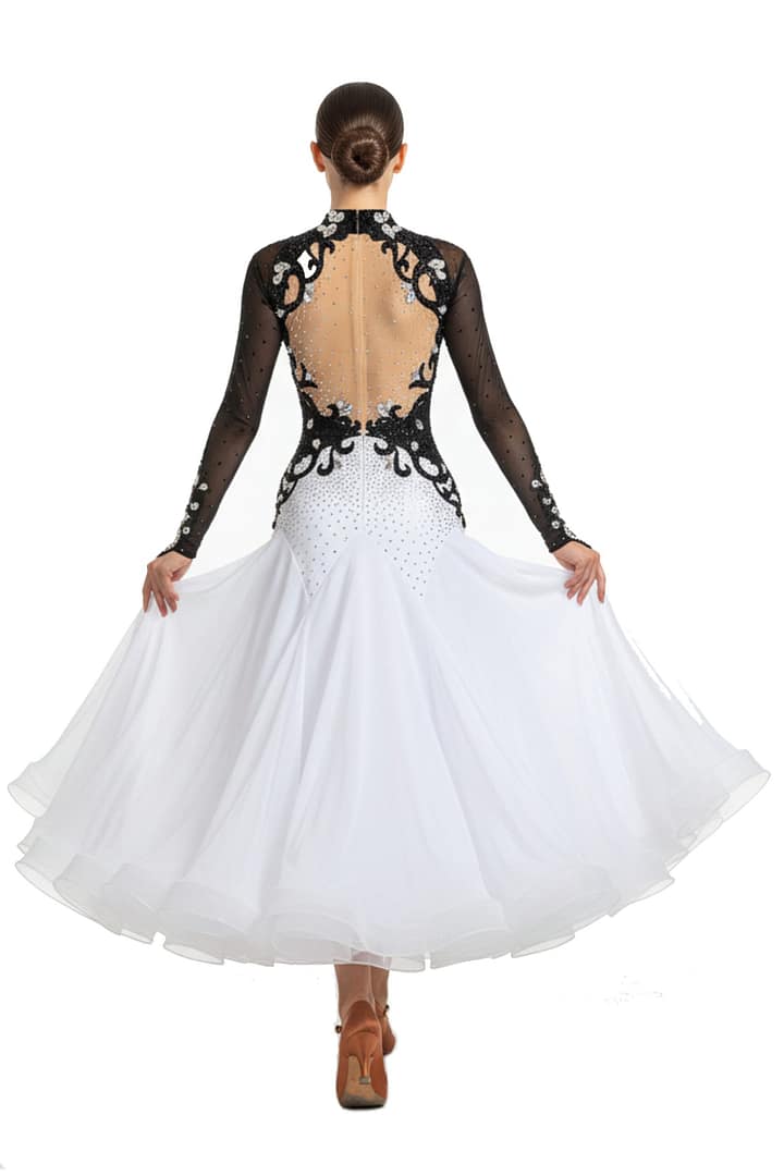 Lauren ballroom gown — back view — Long-sleeved black and white dress with a deep open-back design edged with black scrolling appliqué and clear crystals, over a nude mesh panel, leading to a white stoned skirt.