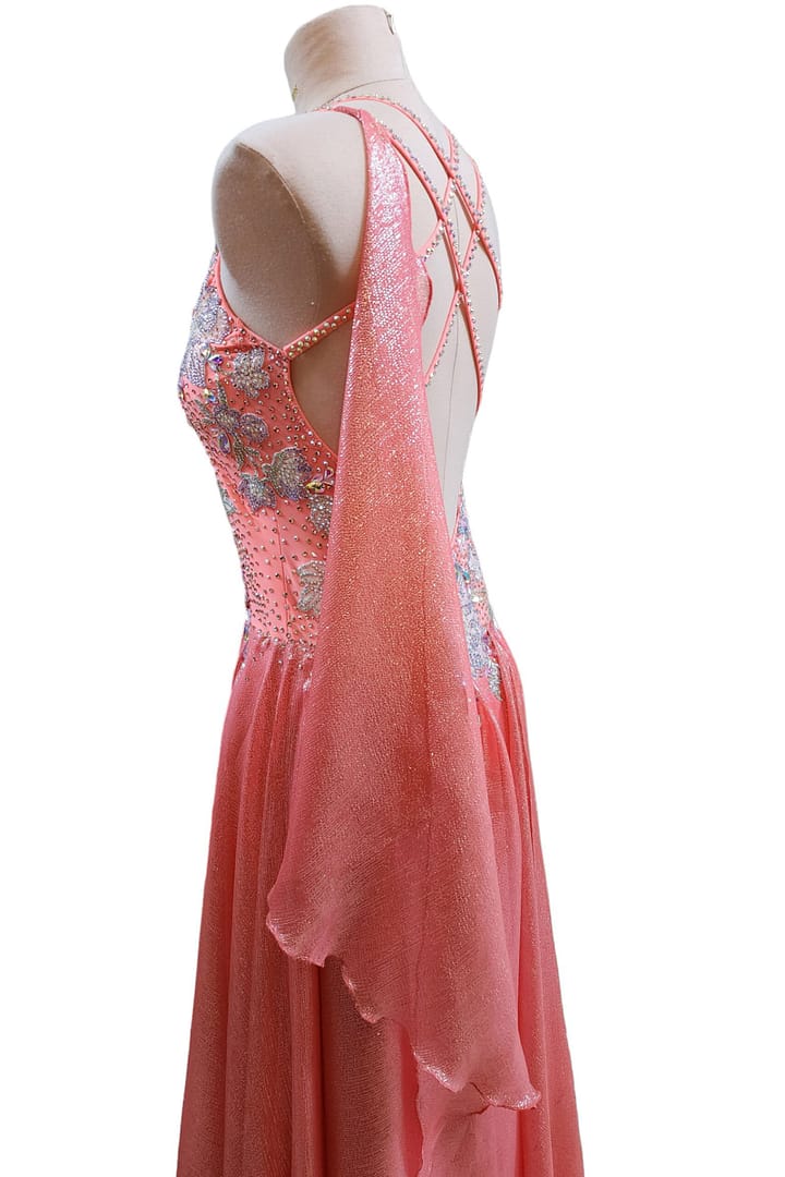 Ziva Ballroom Dress — 3/4 side view — coral gown with flowing skirt and iridescent stonework