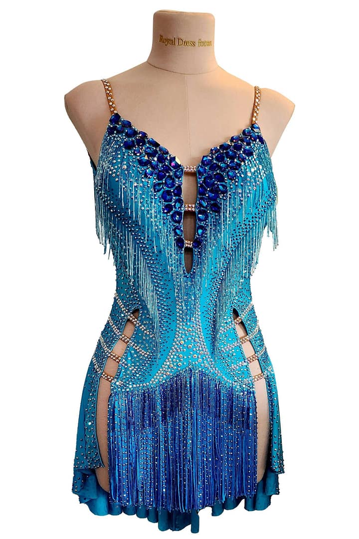 Carla Latin dress -front view - on mannequin - Vibrant blue with heavy fringe, deep V-neck, and dark blue crystal V-pattern.