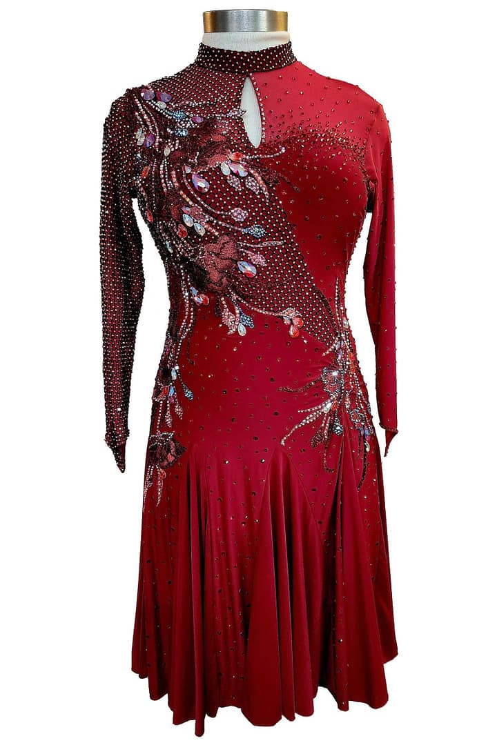 Talia Latin dress - front view - on mannequin - Burgundy velvet base with high collar, keyhole neckline, and asymmetrical crystal pattern.