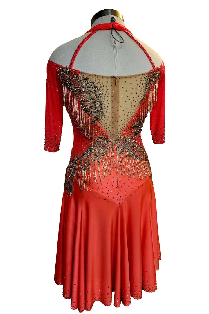 Crush Latin dress — back view on mannequin — open back with nude chiffon floats and multi-layered orange fringe.