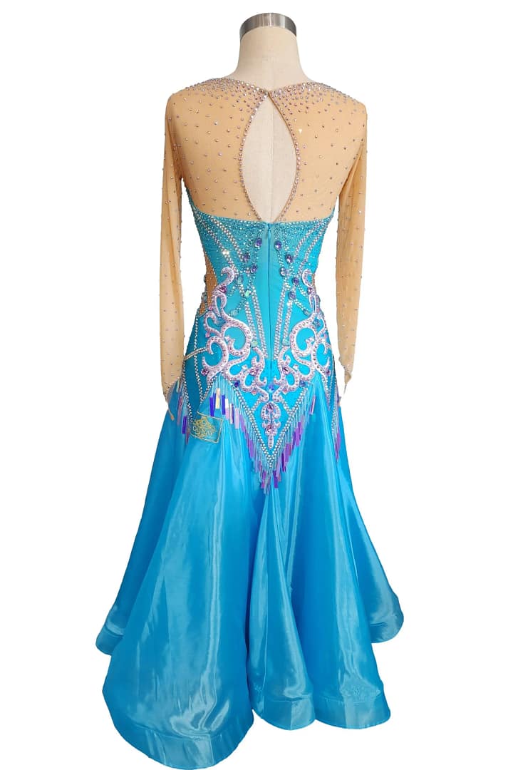 Jackie ballroom gown — back view — blue dress with a keyhole back opening and elaborate white, purple, and iridescent crystal stoning on the fitted bodice.