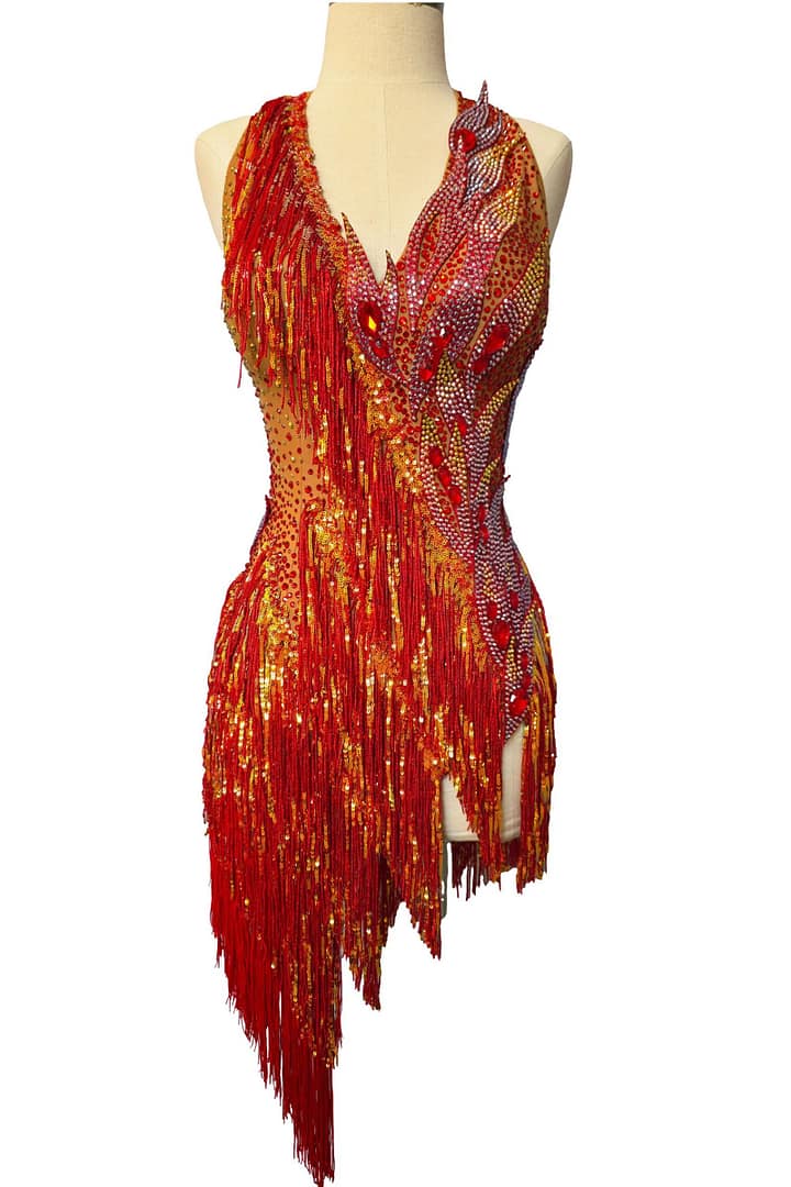 Front view of Inferno Cascade Latin dance dress on mannequin with cascading red and gold fringe and crystal-studded bodice.