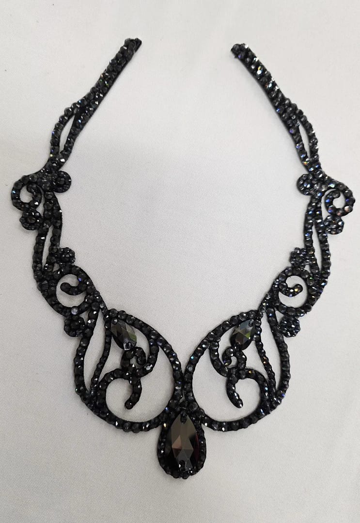 Front view of black crystal ballroom necklace with symmetrical scroll pattern and graphite crystal centerpiece